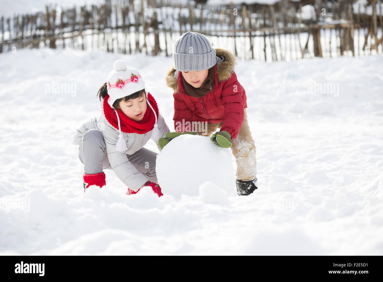 Dei bambini felici snowball di laminazione insieme Foto Stock