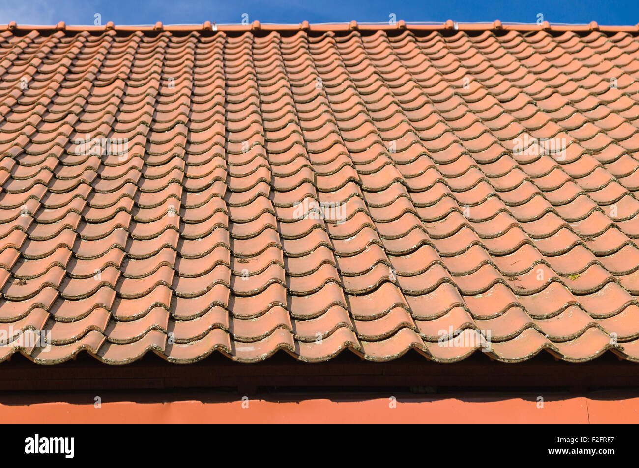 Orange tegole del tetto lo sfondo con il bordo del cielo Foto Stock