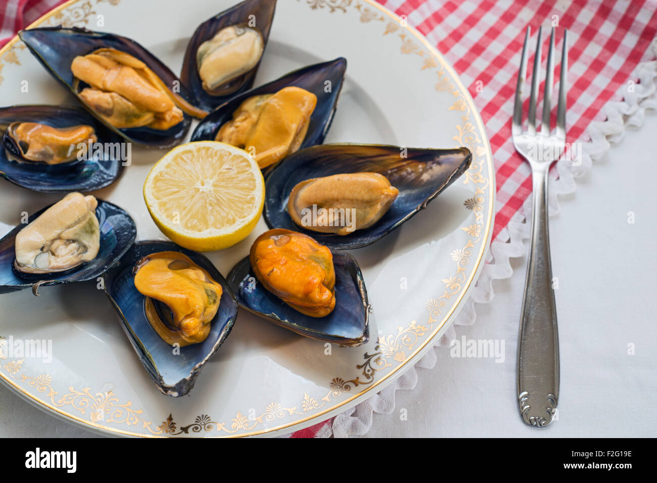 Le cozze al vapore sulla tovaglia a scacchi Foto Stock