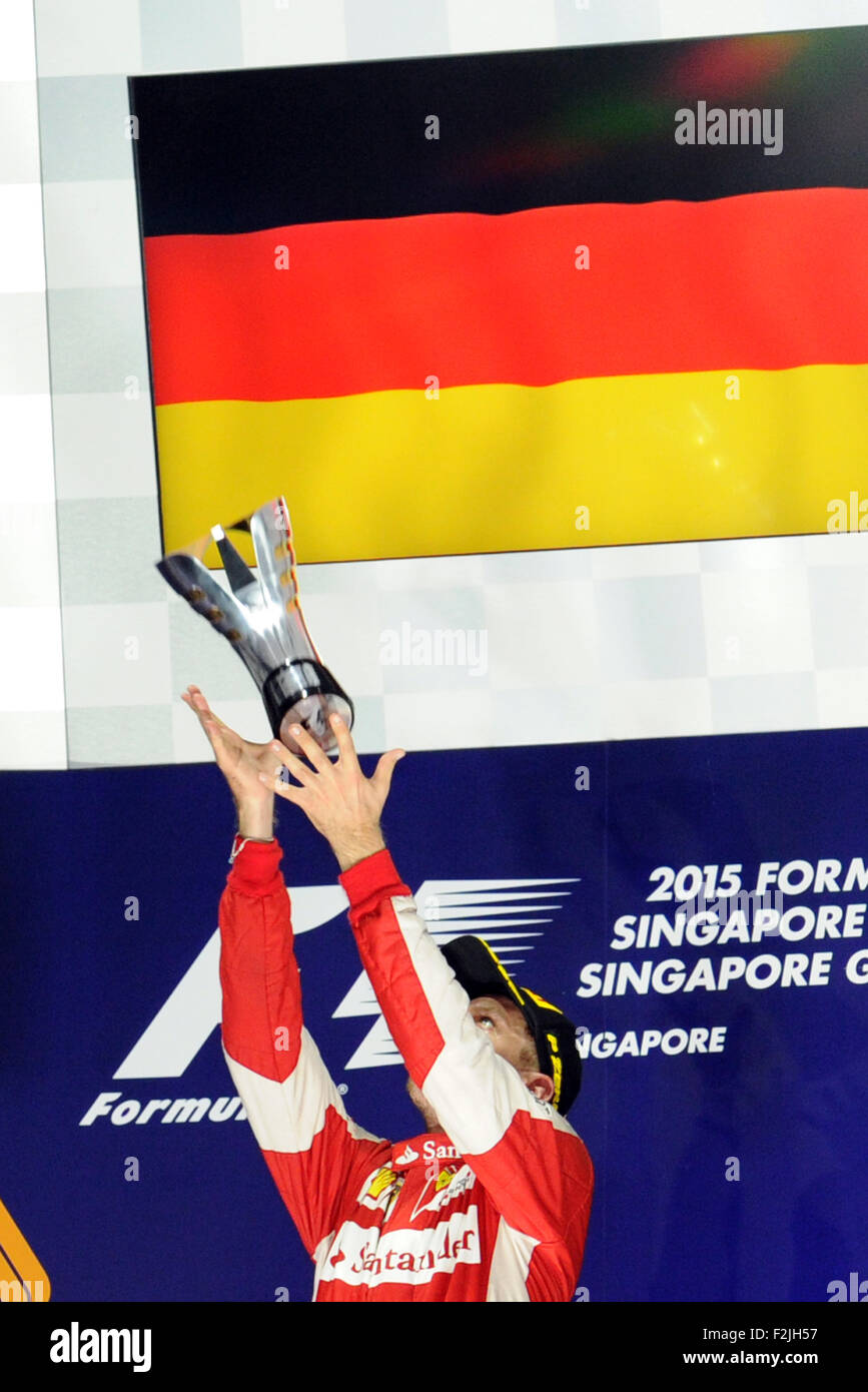 Singapore. Xx Settembre, 2015. Il team Ferrari driver Sebastian Vettel celebra la sua vittoria sul podio durante il 2015 F1 Grand Prix di Singapore (GP) gara in notturna a Singapore F1 Pit Building, sul Sett. 20, 2015. Sebastian Vettel ha vinto la F1 GP di Singapore gara notturna svoltasi a Singapore il circuito cittadino di Marina Bay. Credito: Quindi Chih Wey/Xinhua/Alamy Live News Foto Stock