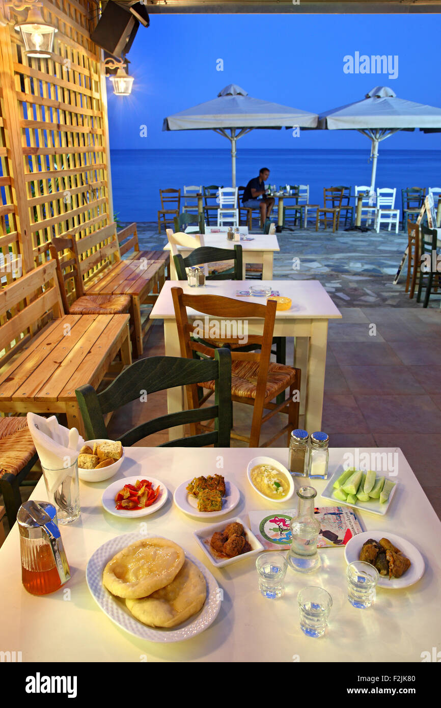 Tavolo con tradizionale cretese e alimentare il raki, il tradizionale cretese drink presso la taverna nella città di Ierapetra, Lassithi, Creta, Grecia Foto Stock
