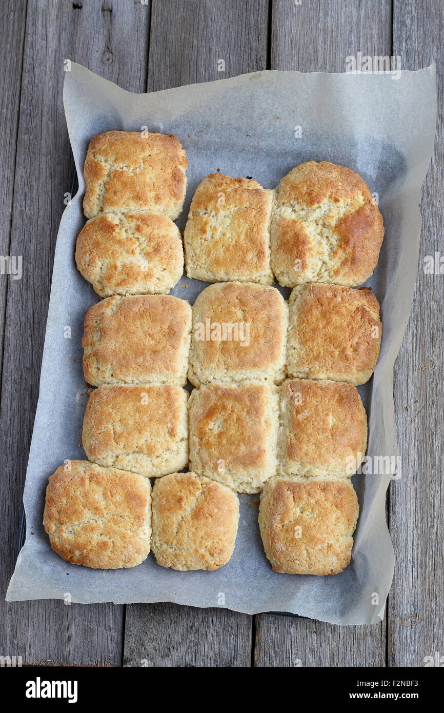 Pane appena sfornato focaccine fatte in casa in una teglia da forno su una tavola di legno Foto Stock