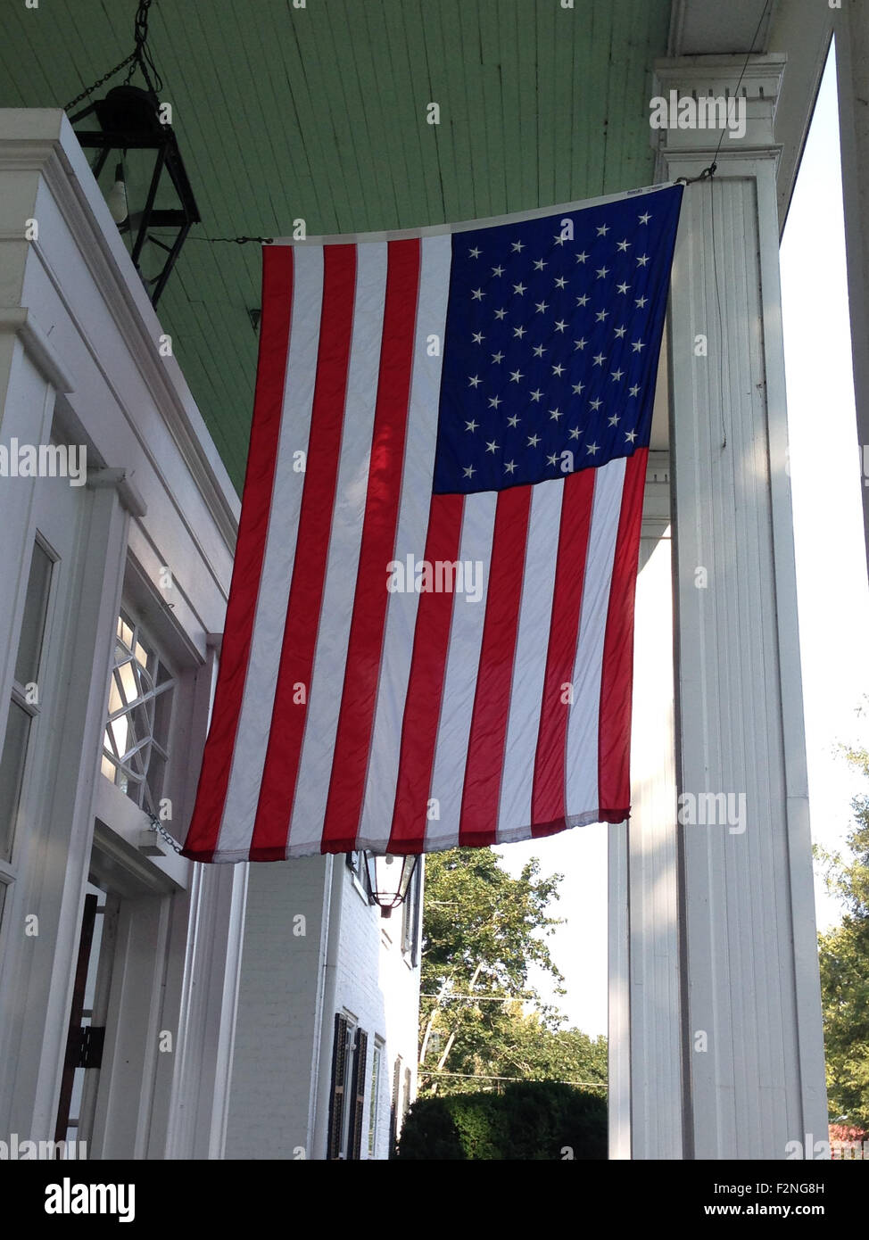 Bandiera americana appesa da casa - Immagine stock catturata con smartphone