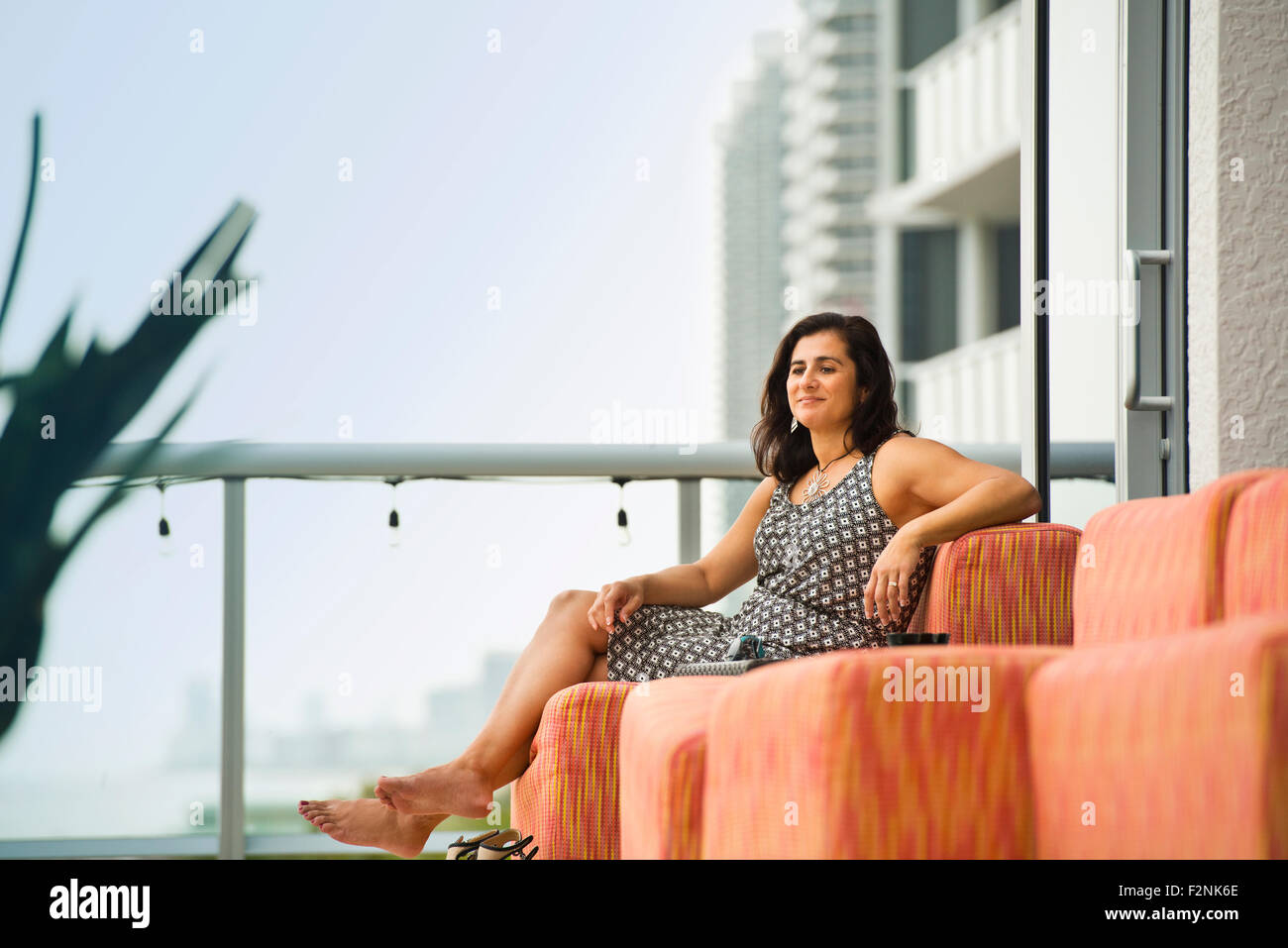 Ispanico donna seduta sul balcone hotel Foto Stock