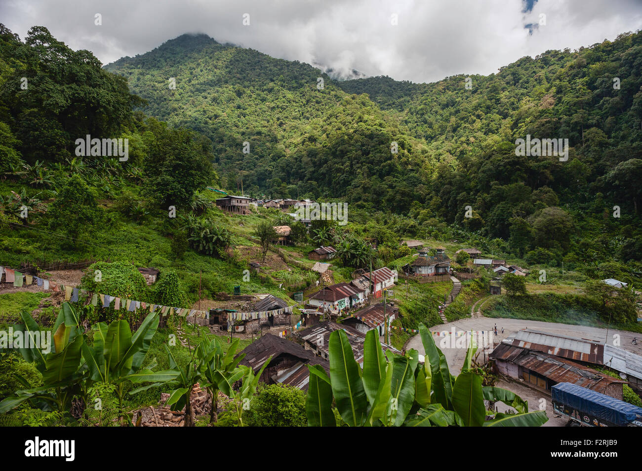 Baraccopoli circondata da vegetazione e montagne lungo la strada principale tra Assam e Tawang, Arunachal Pradesh, India. Foto Stock