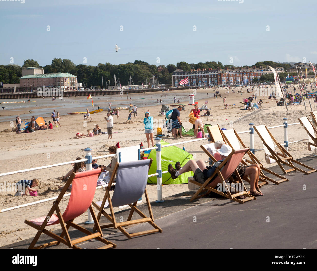Vacanzieri godere di sole sulla spiaggia di sabbia a Weymouth Dorset, England, Regno Unito Foto Stock