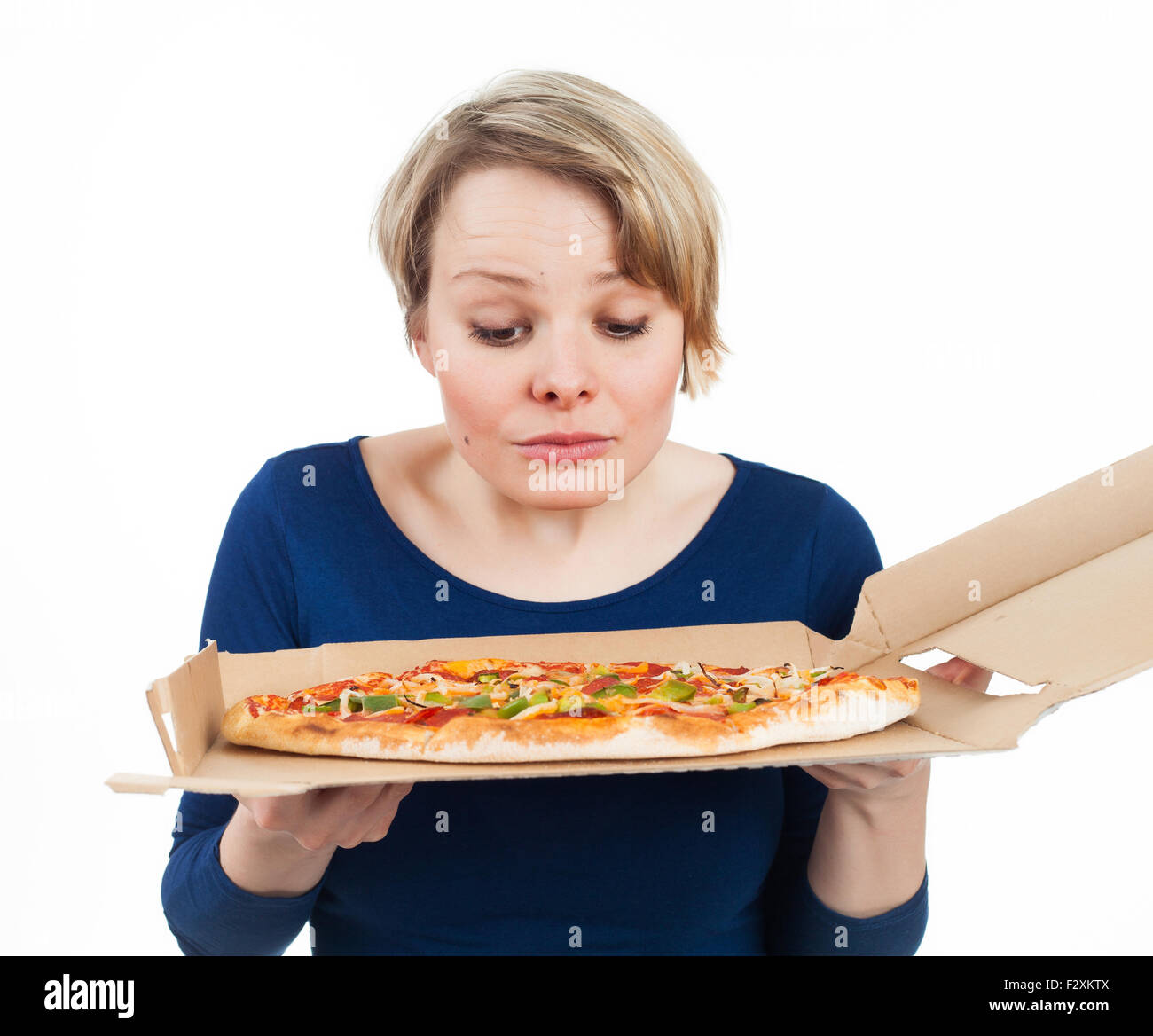Giovane donna guardando una pizza dal fast food e guardando molto attratto, isolato su bianco Foto Stock