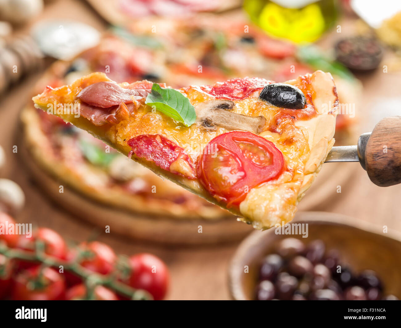 Pezzi di pizza con funghi, prosciutto e pomodori. Vista dall'alto. Foto Stock