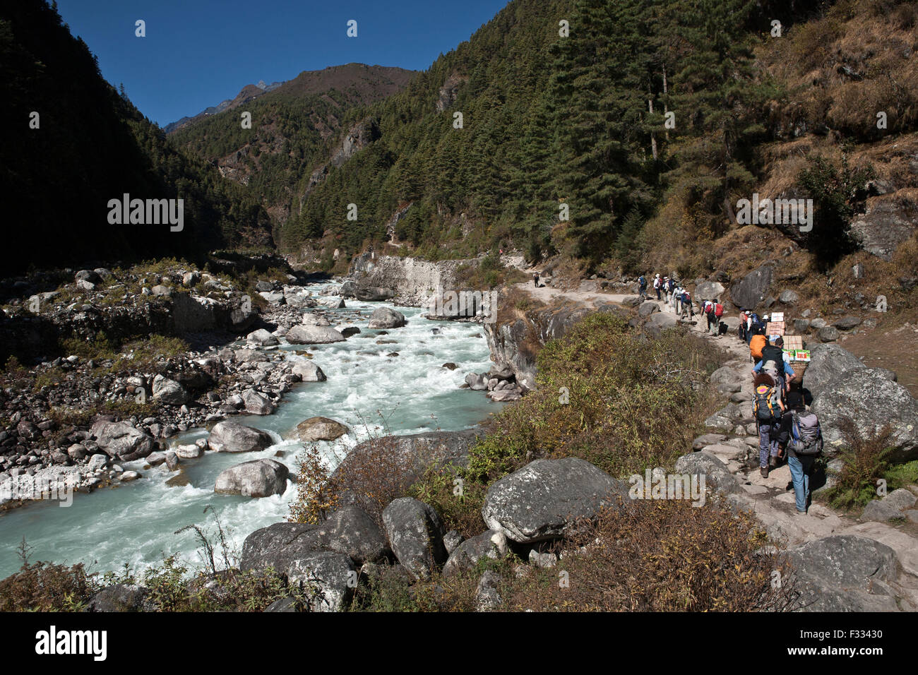 I viaggiatori sul sentiero lungo il fiume Dudhkoshi Nepal Foto Stock