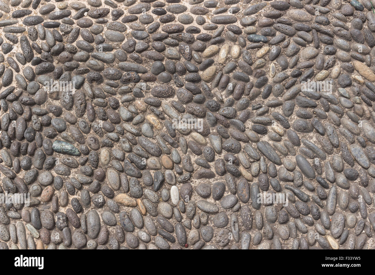 Lo sfondo o la tessitura di un cobblestone pavement Foto Stock