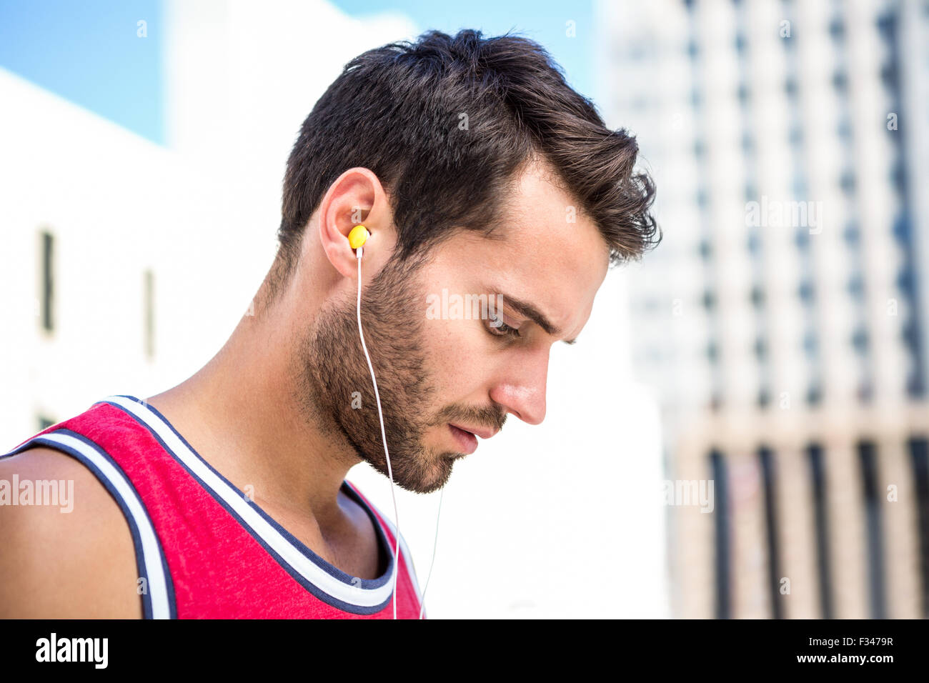 Serio atleta bello ascoltare musica Foto Stock