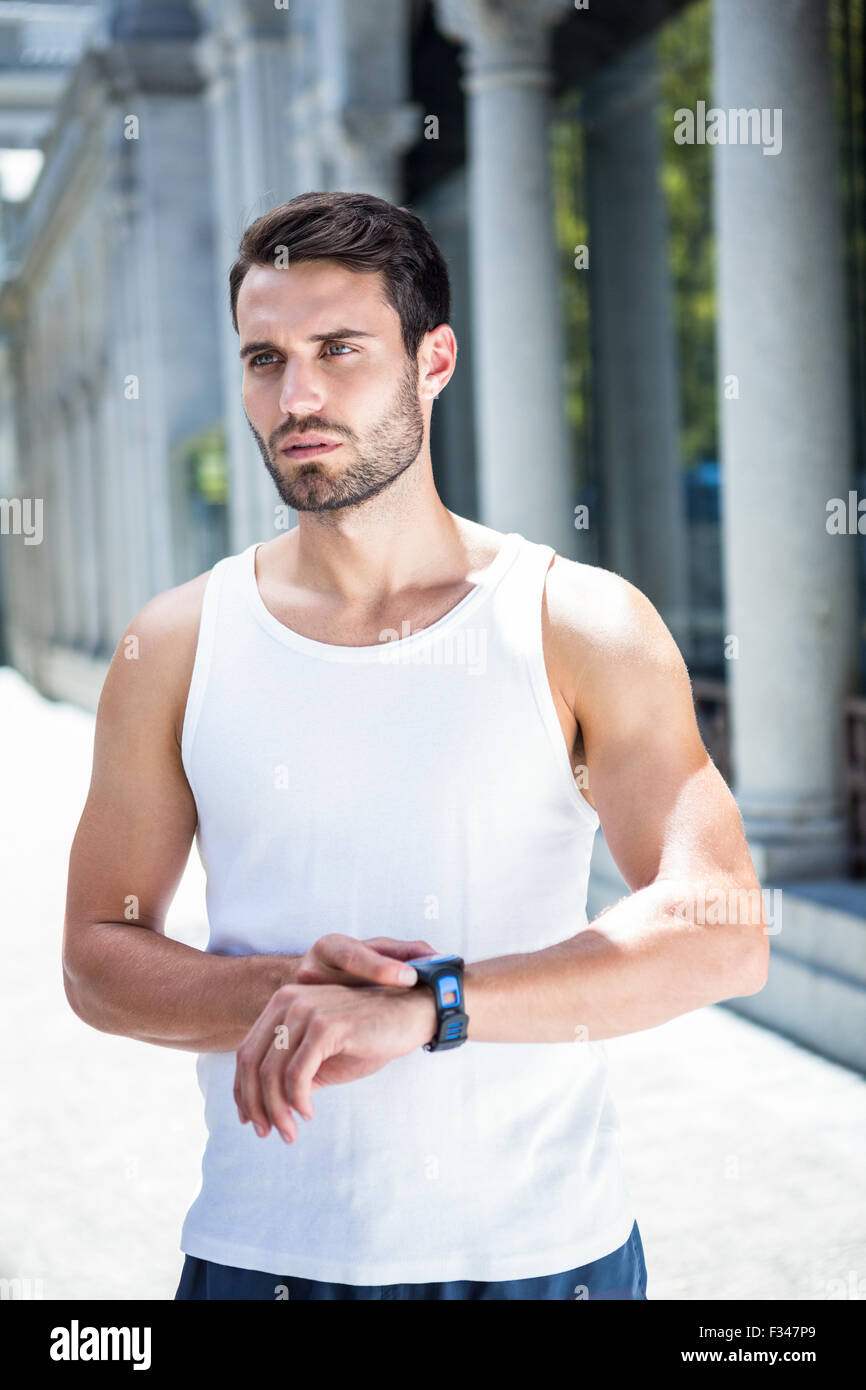 Bello concentrato atleta controllare la frequenza cardiaca watch Foto Stock