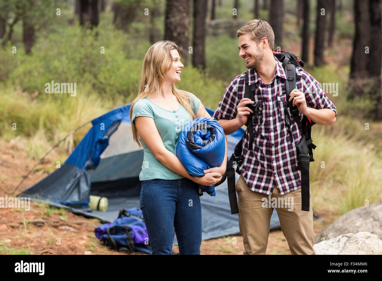 Giovani piuttosto escursionista giovane tenendo un sacco a pelo e zaino Foto Stock