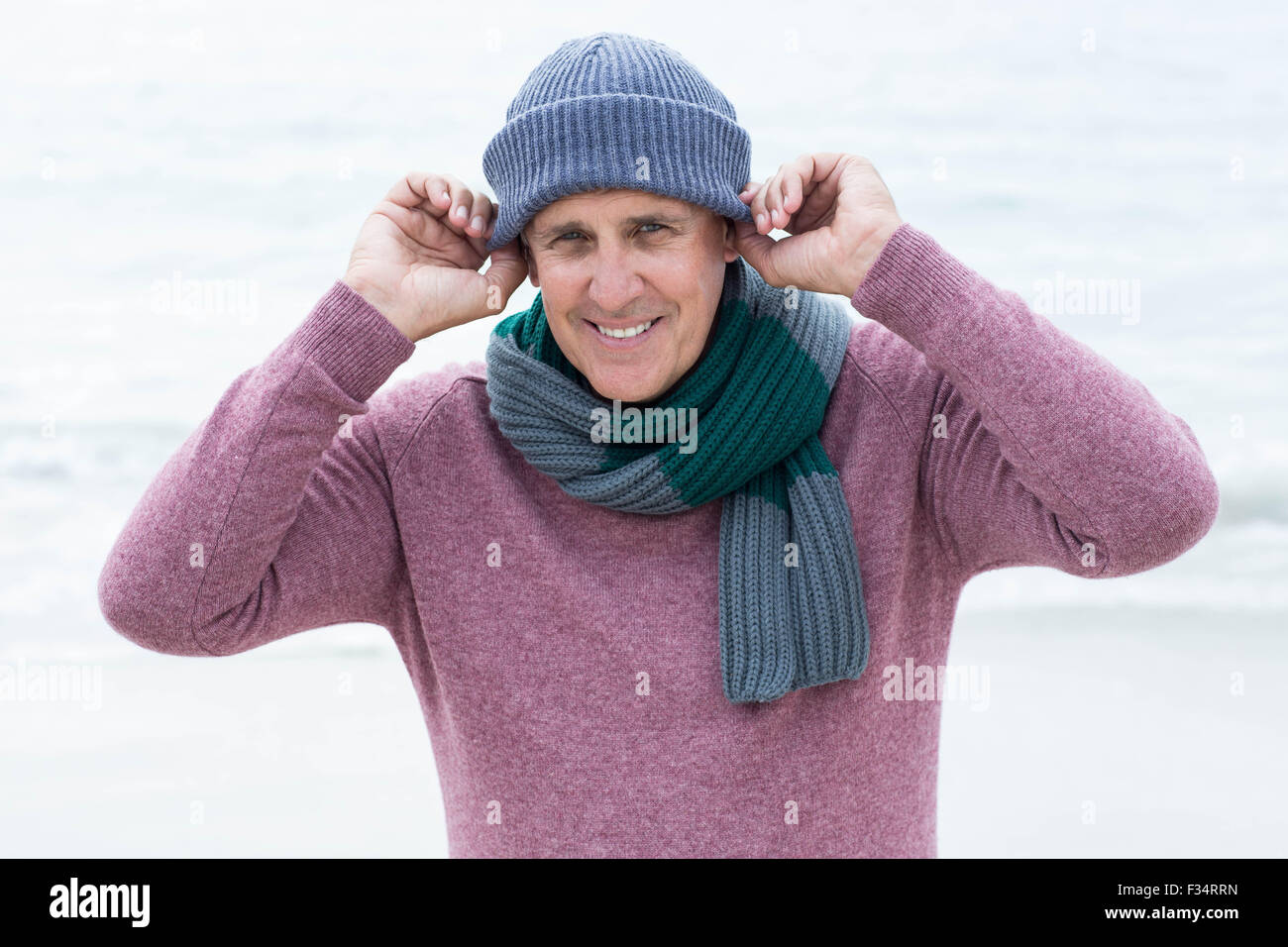 Uomo sorridente indossando vestiti caldi Foto Stock