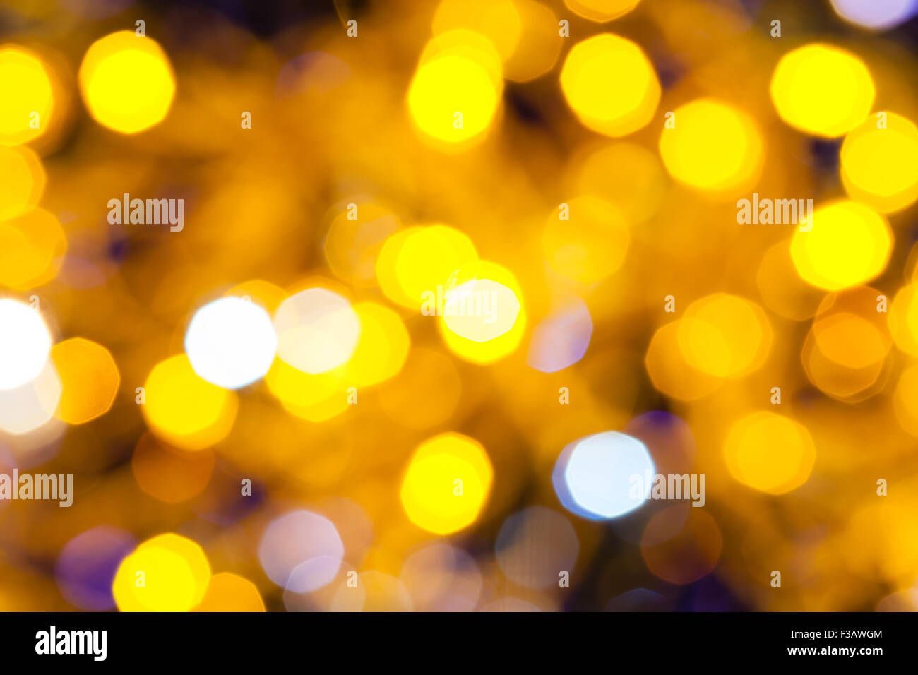Abstract sfondo sfocato - blu scuro e giallo scintillanti luci di Natale bokeh di le ghirlande elettriche su albero di Natale Foto Stock