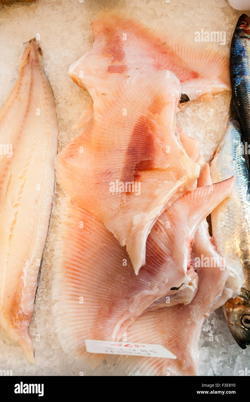 Pescheria, wet-pescheria. Filetti di pesci di pattino visualizzate sul ghiaccio tritato a mercanti di pesce. Rosa carne di pesce con pattern di linee. Foto Stock