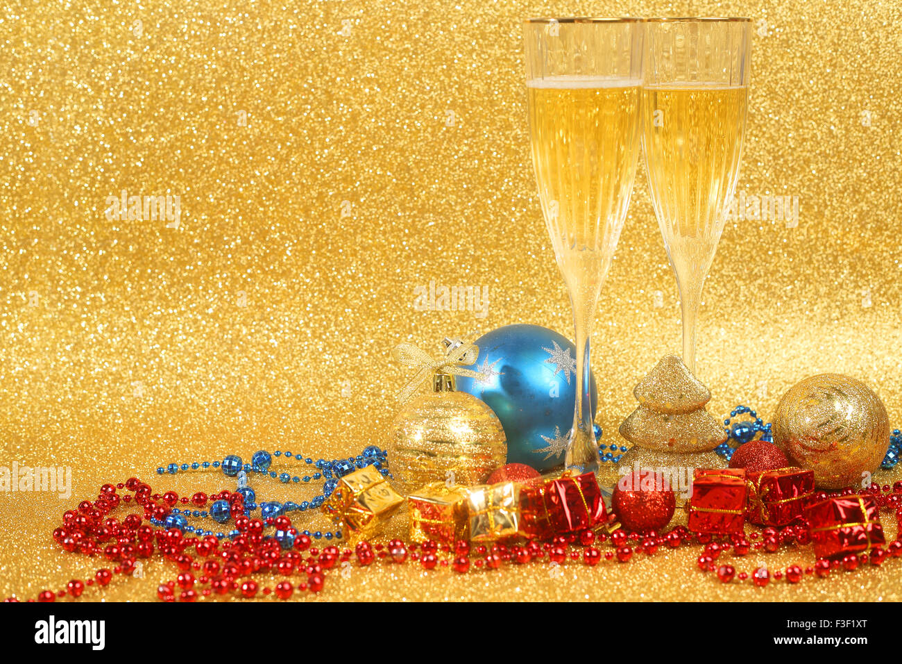 Champagne e decorazioni di Natale sul golden glitter sfondo con spazio di copia Foto Stock