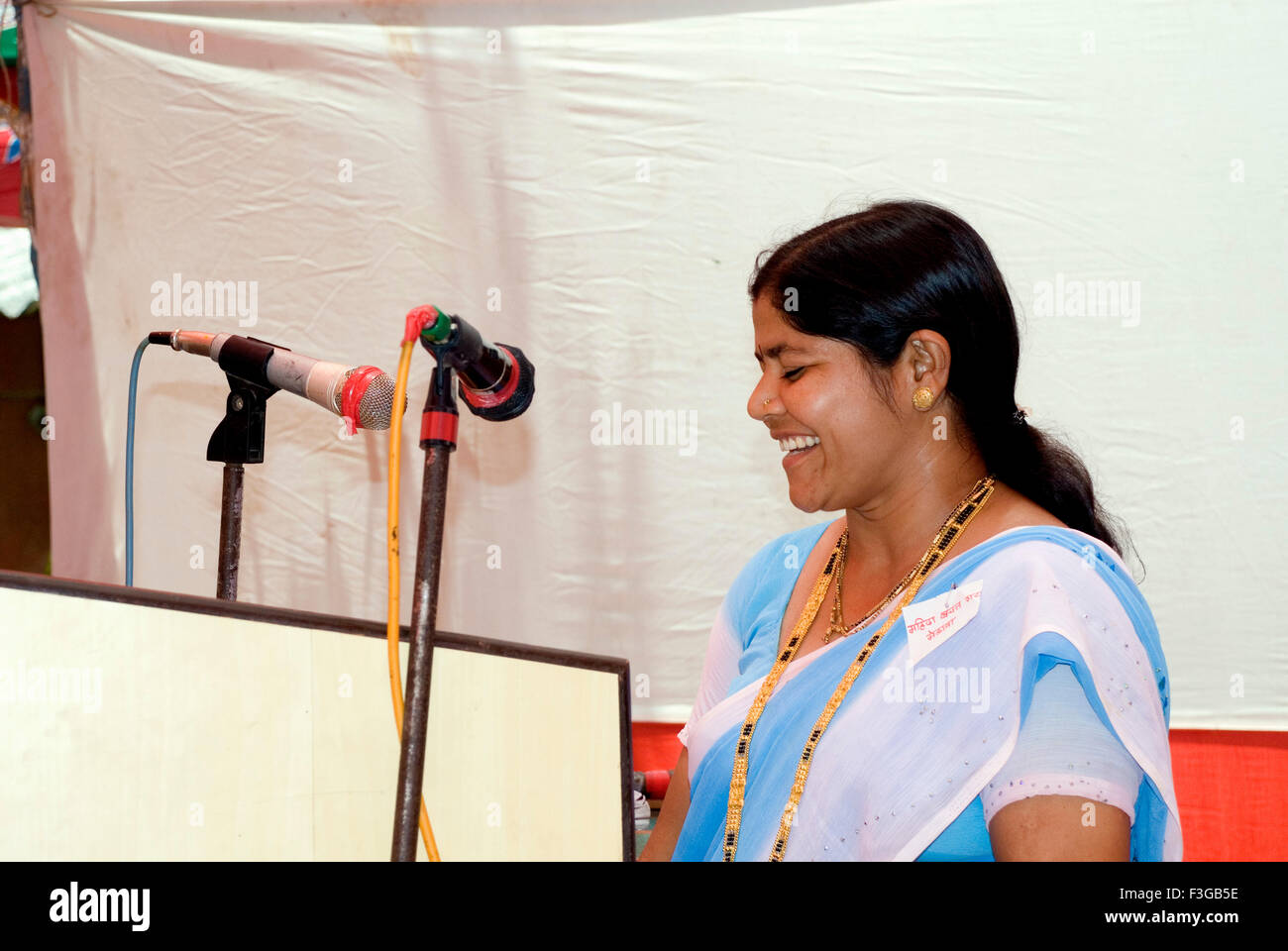 Self Help Group leader dando il discorso in funzione al villaggio di nere; Taluka Panvel; Maharashtra, India Foto Stock