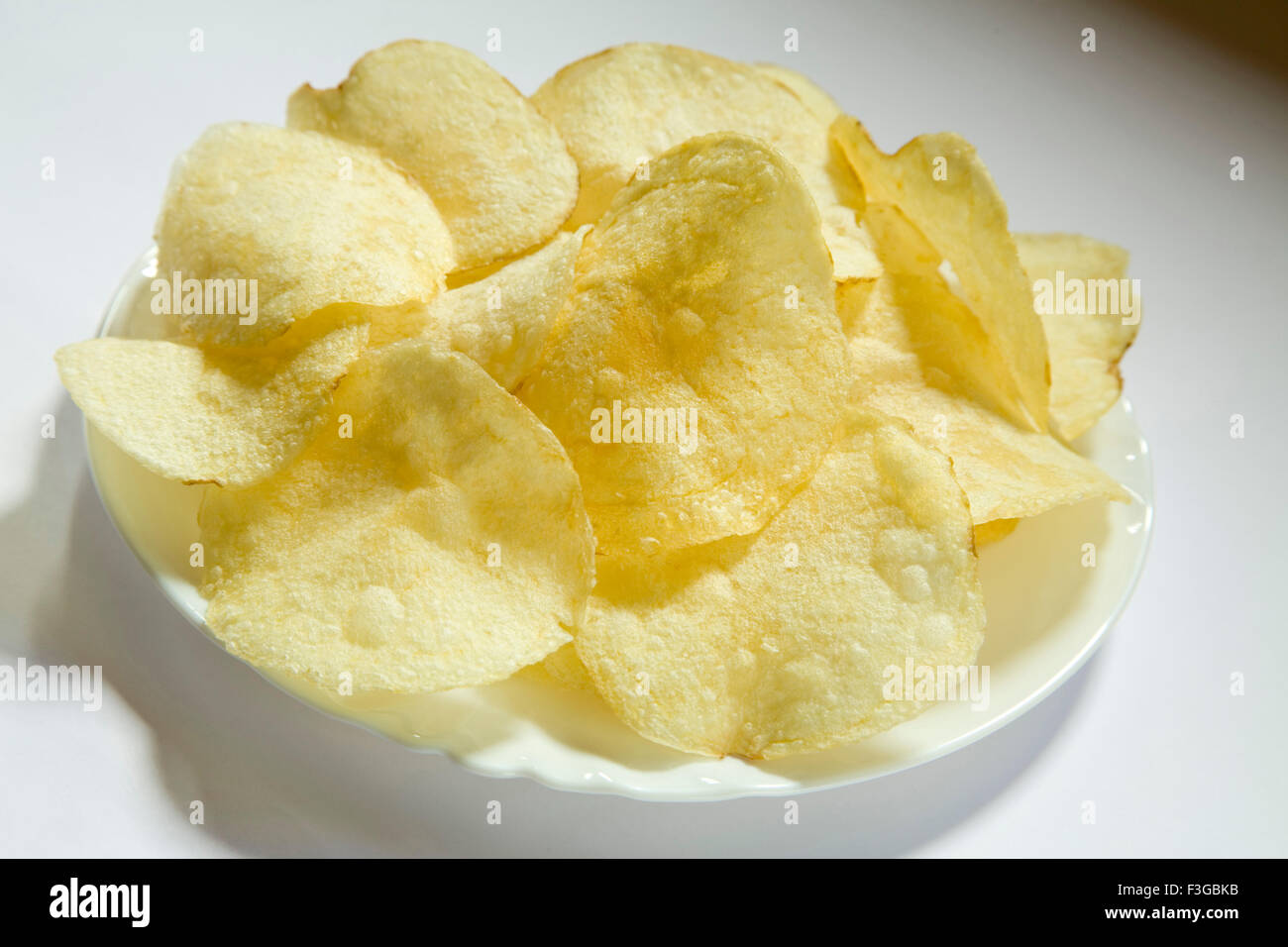 Junk food snack salato patatine o fetta servita nella piastra Foto Stock