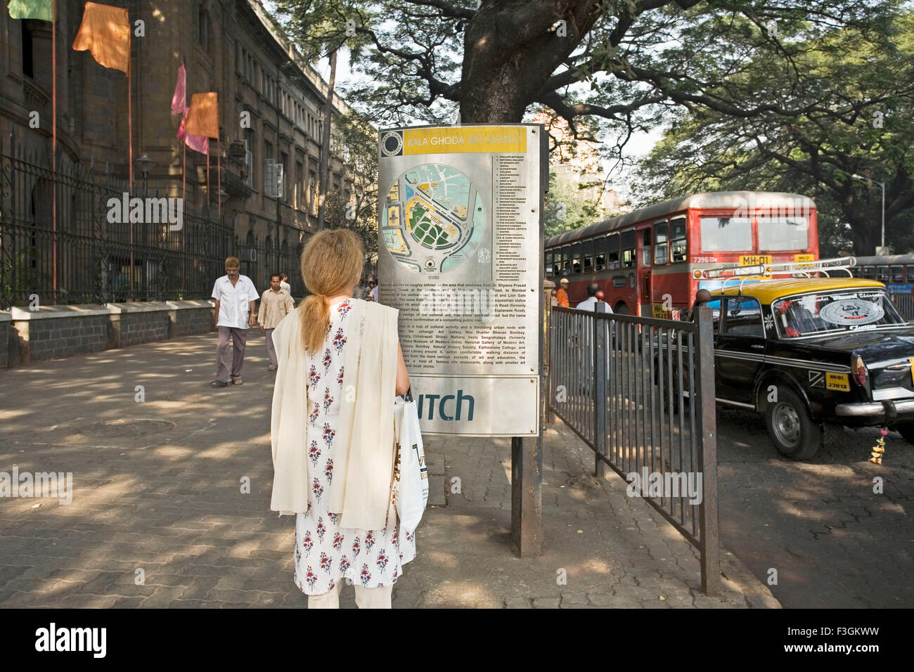 Un visitatore la lettura delle informazioni sul Kala Ghoda Art District ; Fort ; Bombay ora Mumbai ; Maharashtra ; India Foto Stock