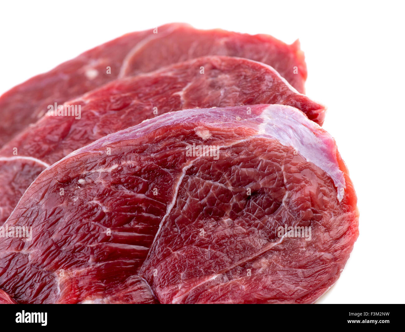 Macro closeup di gamba di agnello bistecche di carne isolato su bianco Foto Stock