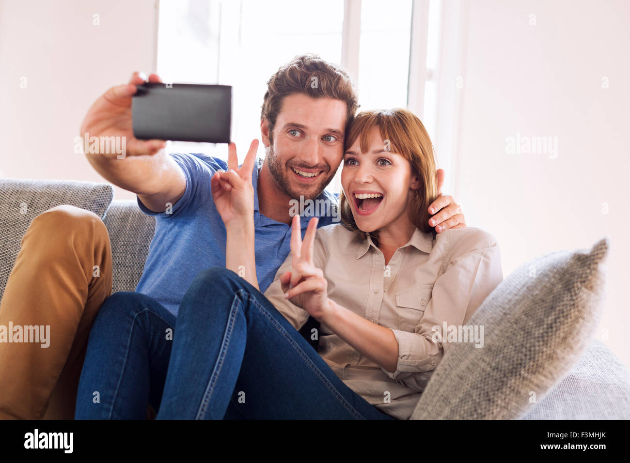 Happy Fun giovane prendendo un selfie con un telefono cellulare. La felicità, godimento Foto Stock