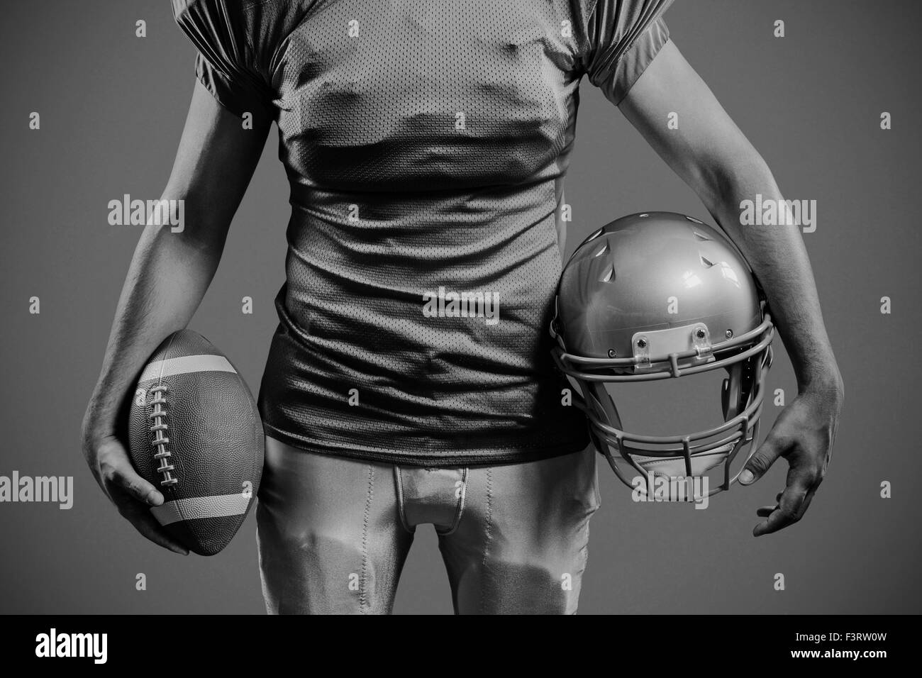 Immagine composita della sezione centrale della holding sportivo football americano e casco Foto Stock
