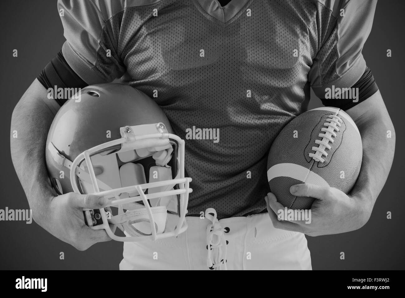 Immagine composita di sorridere giocatore di football americano guardando la fotocamera Foto Stock