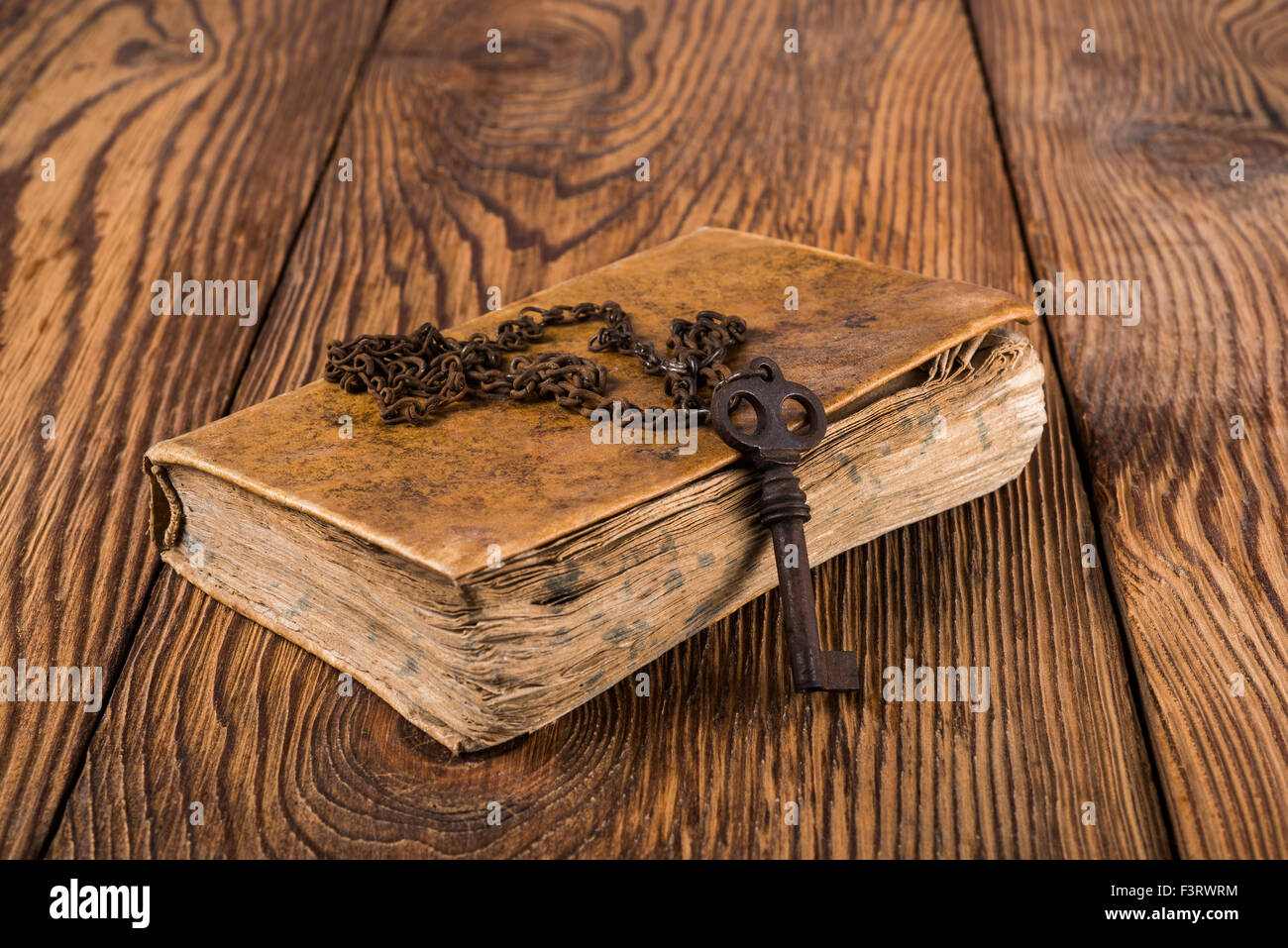 Vecchia chiave con la catena su un libro Foto Stock