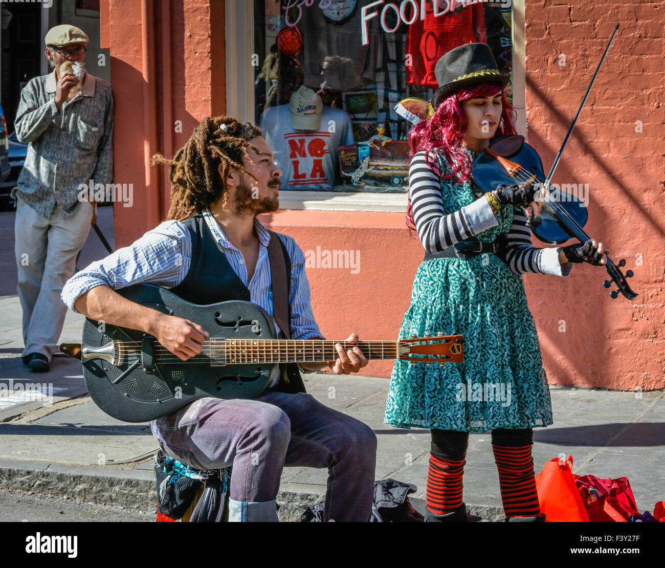 Un colorato giovane riproduzione di un violino e una chitarra sono musicisti di strada del Quartiere Francese di New Orleans, LA Foto Stock