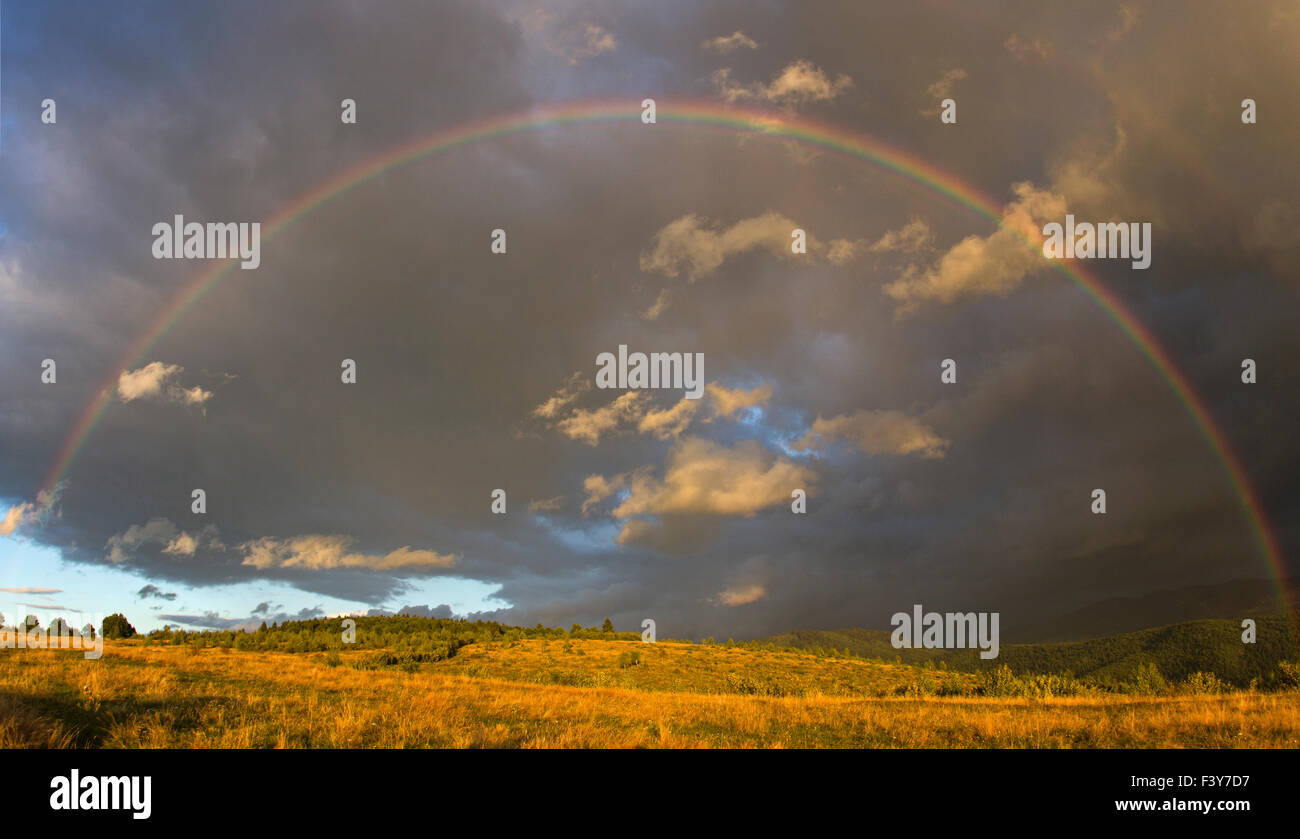 Un bellissimo arcobaleno sopra la parte inferiore dei Carpazi in Transilvania. Foto Stock