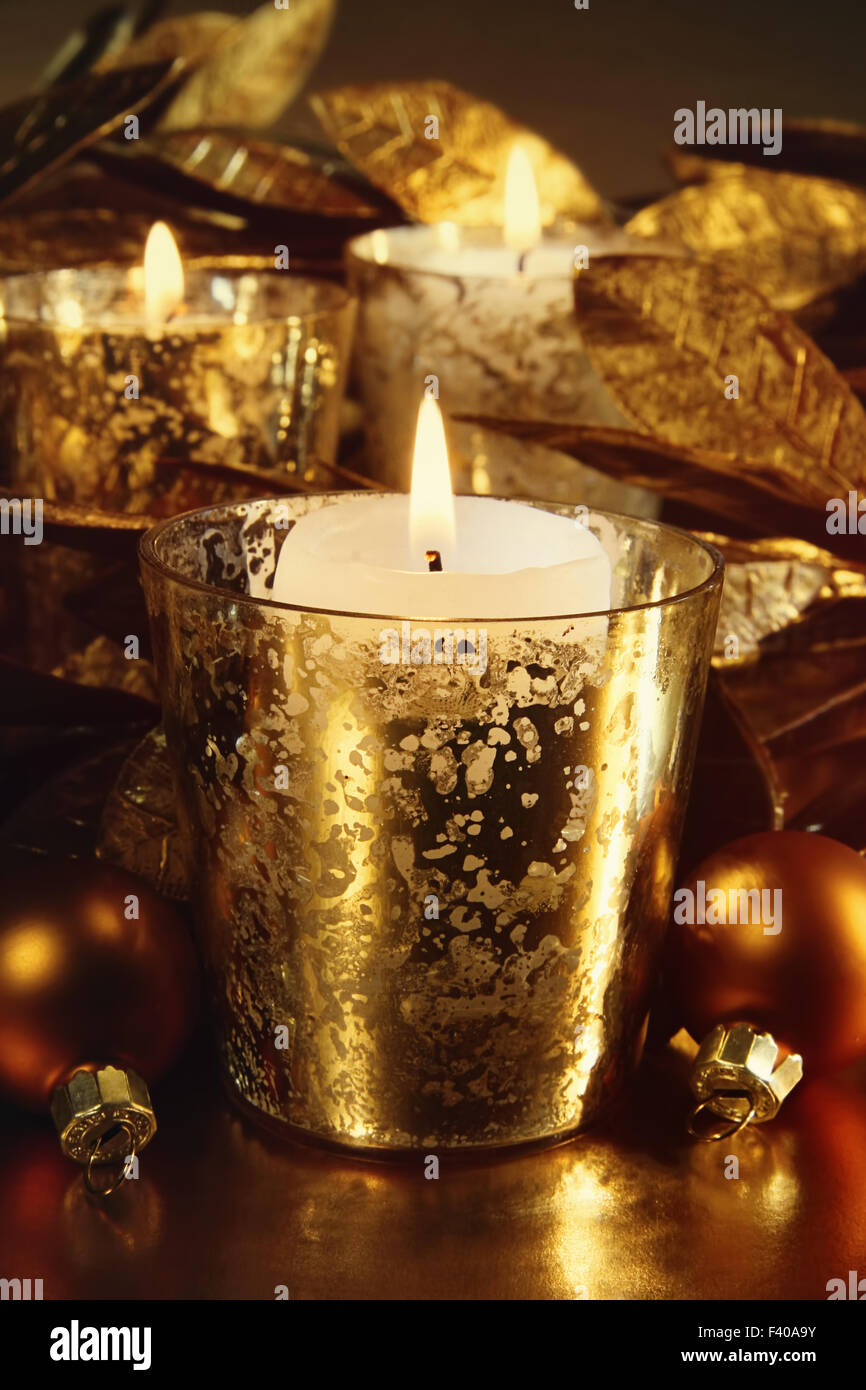 Candele accese con un frizzante tema oro Foto Stock