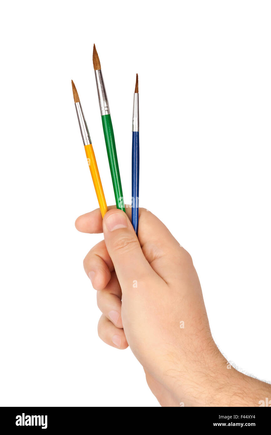 Mano con pennelli multicolore Foto Stock