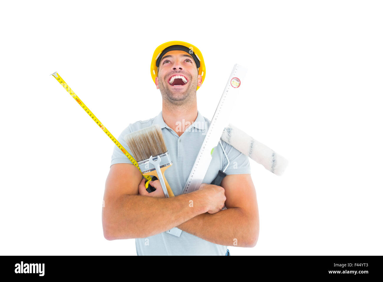 Ridendo lavoratore manuale tenendo vari strumenti Foto Stock