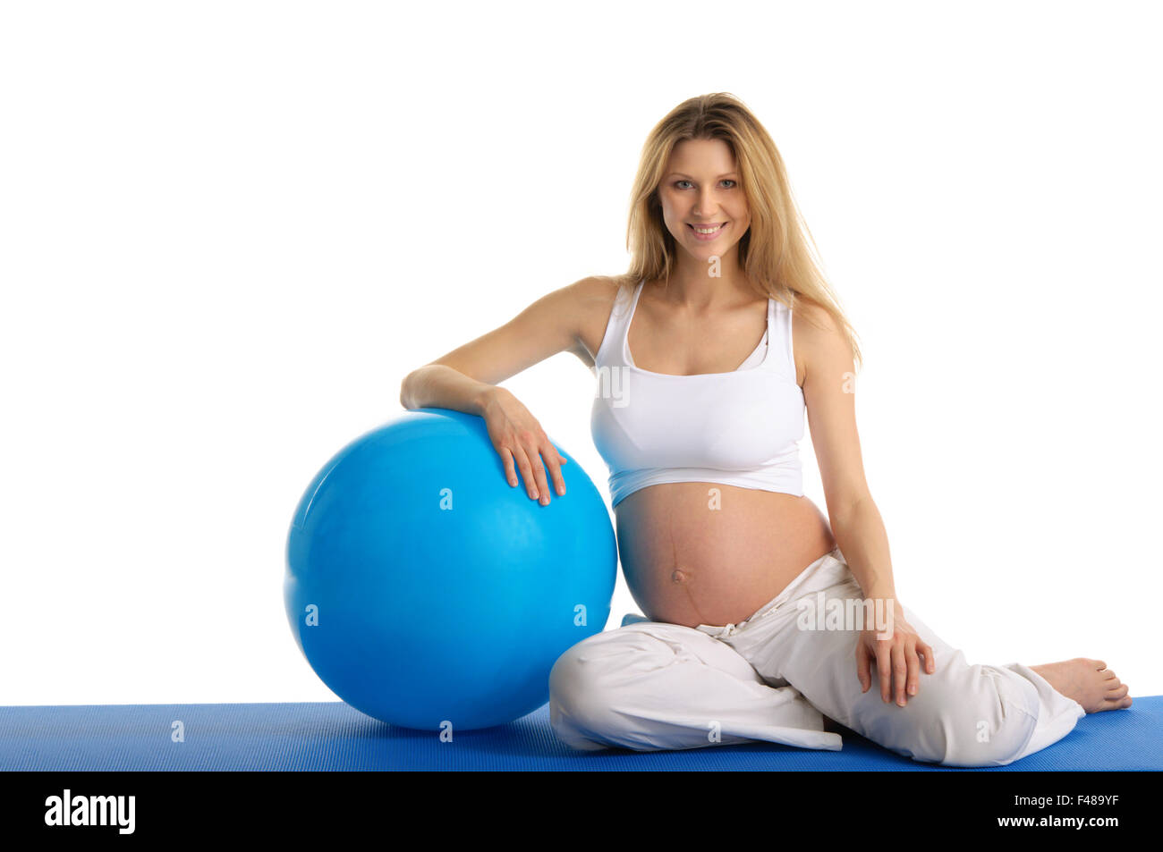 Donna incinta esercizi ginnici con sfera Foto Stock