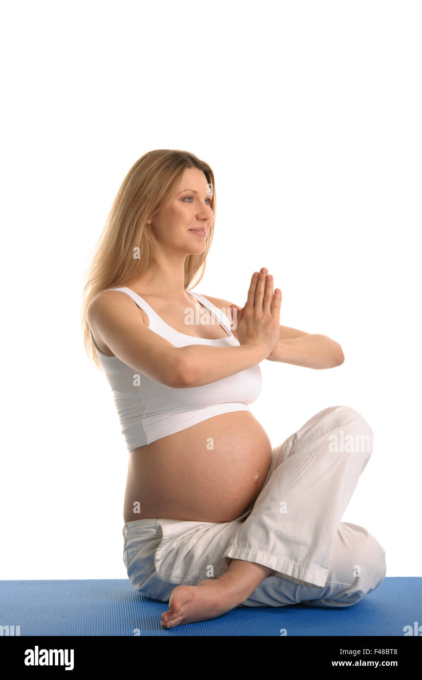 Donna incinta seduta Foto Stock