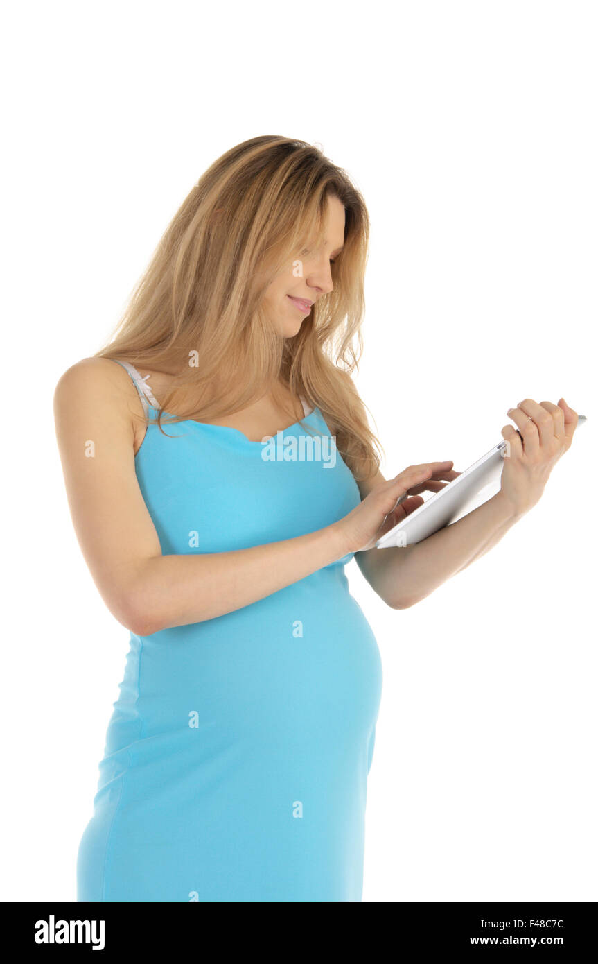 Felice donna incinta con la compressa Foto Stock