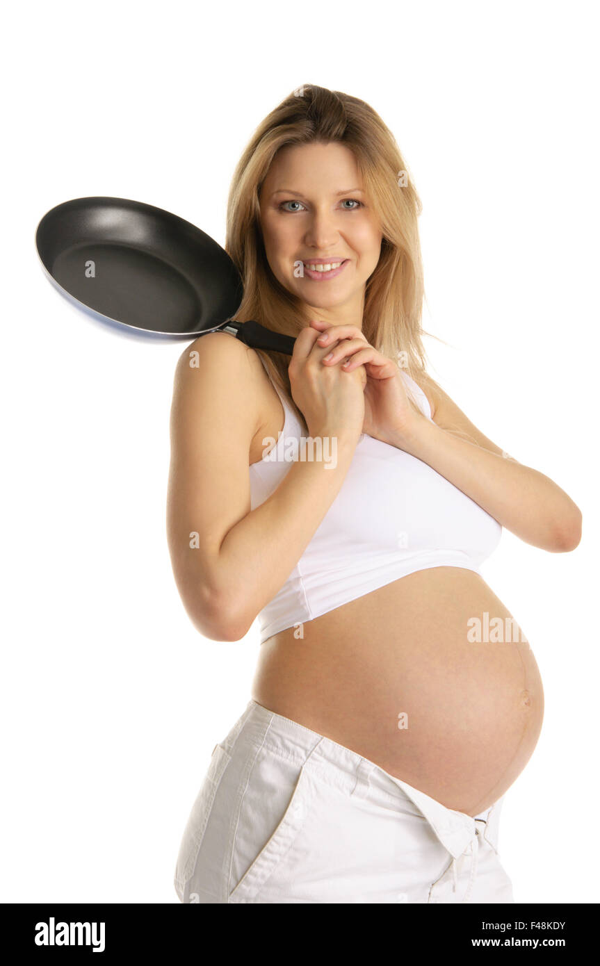 Felice donna incinta con padella Foto Stock