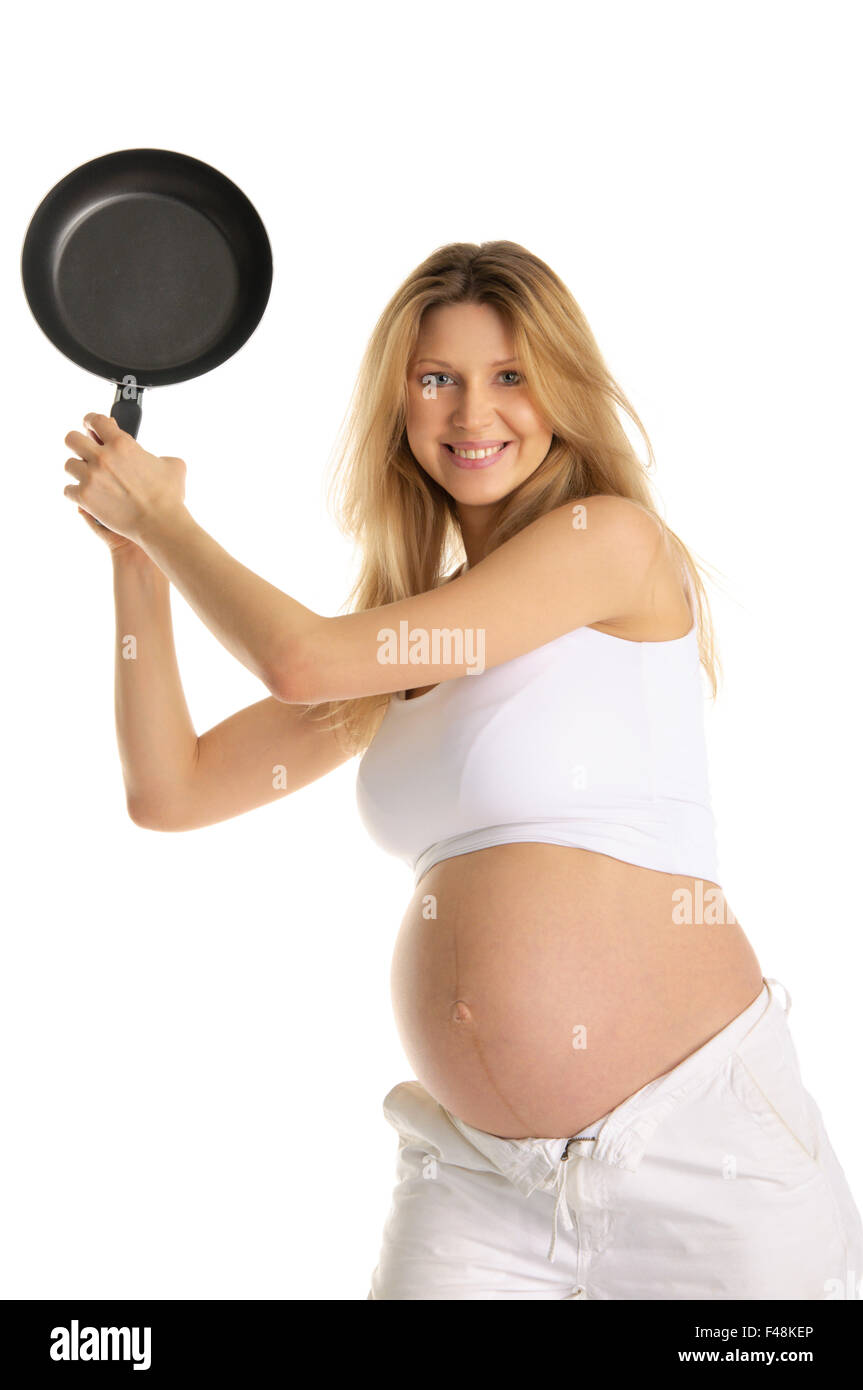 Sorridente donna incinta con padella Foto Stock