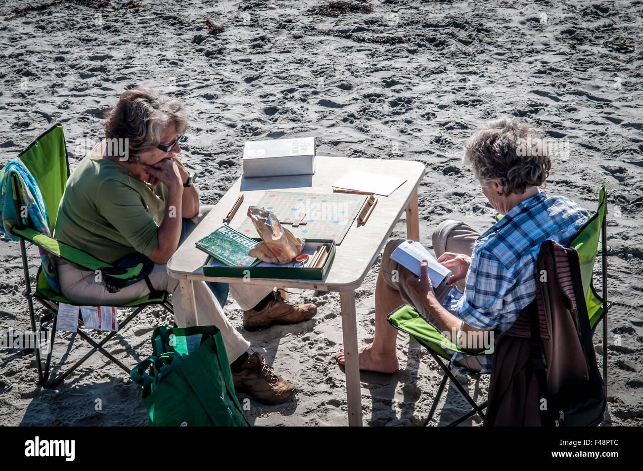 Un sacco di gente andare in spiaggia a piedi, nuotare,sedere e guardare l'oceano. Ma ci sono alcuni che basta andare semplicemente a giocare giochi da tavolo. Foto Stock