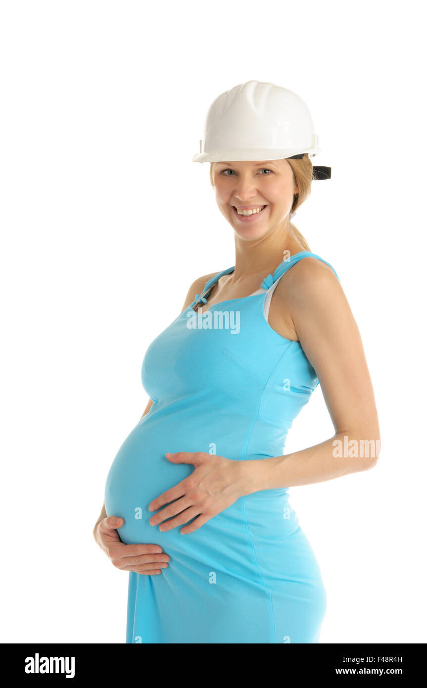 Felice donna incinta nel casco Foto Stock