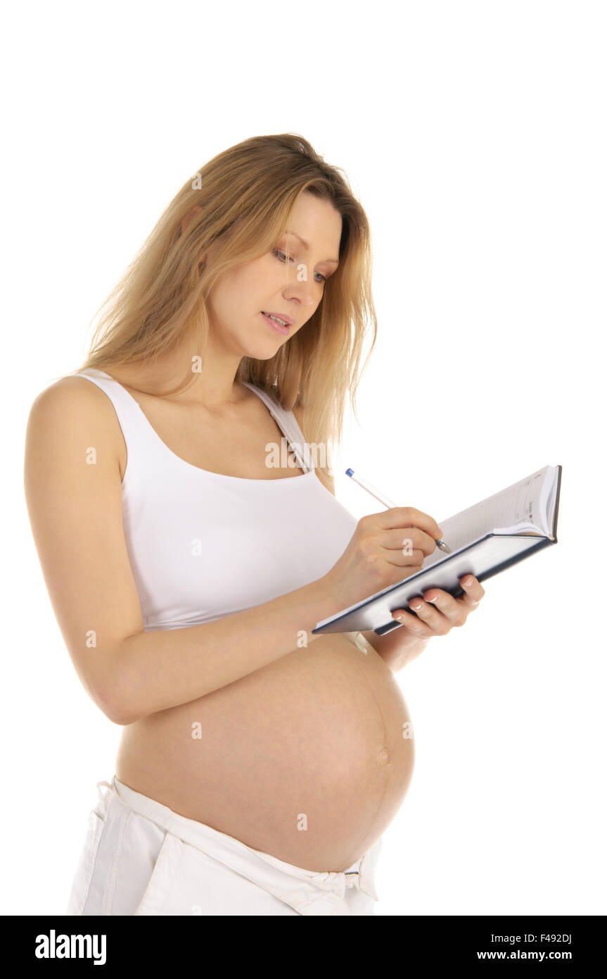 Donna incinta giù in un notebook Foto Stock