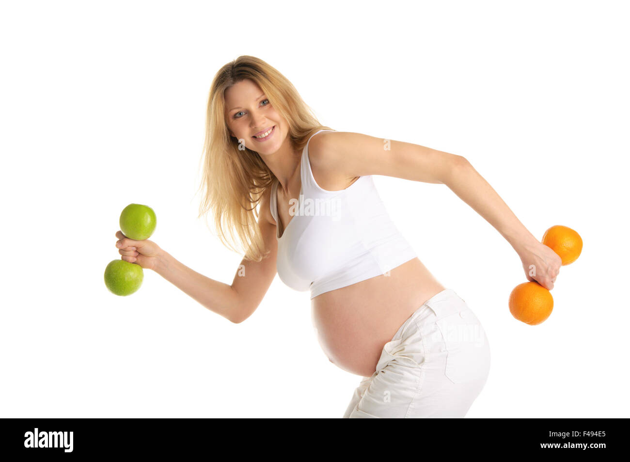 Donna incinta coinvolta nel fitness manubri Foto Stock
