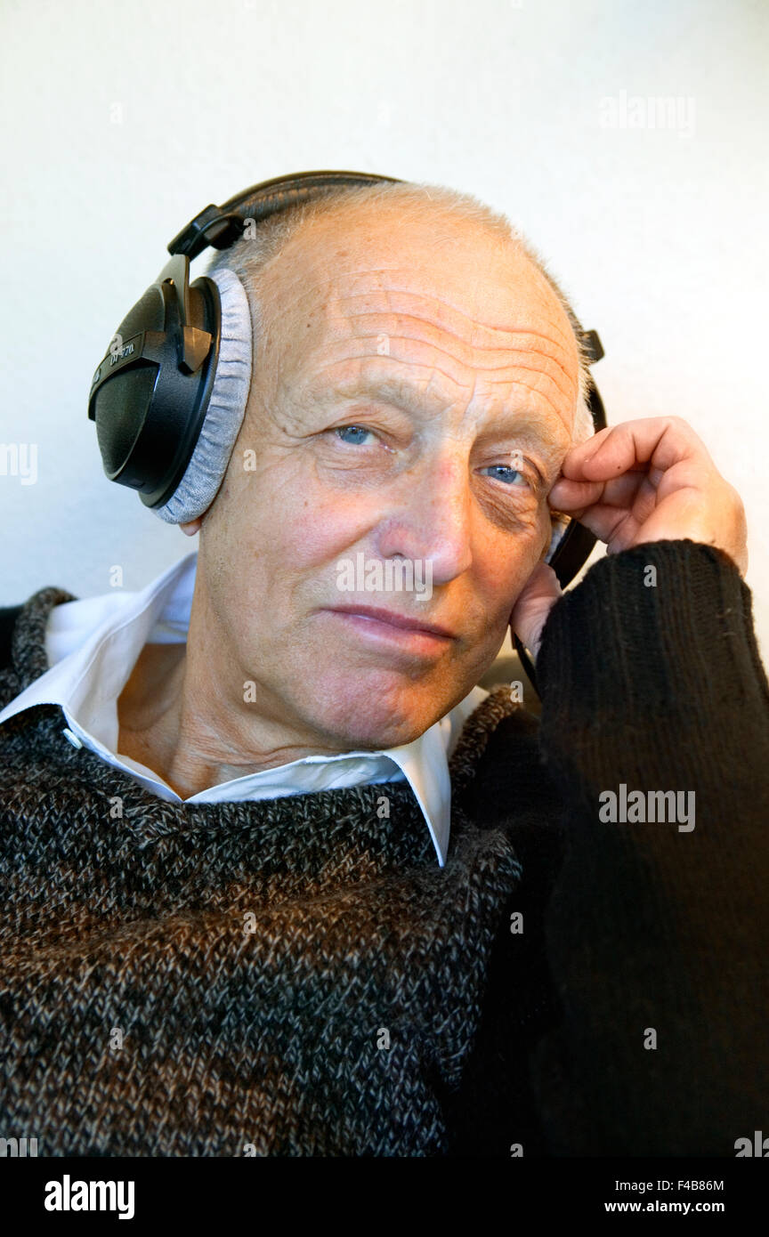 Un vecchio uomo con le cuffie. Foto Stock