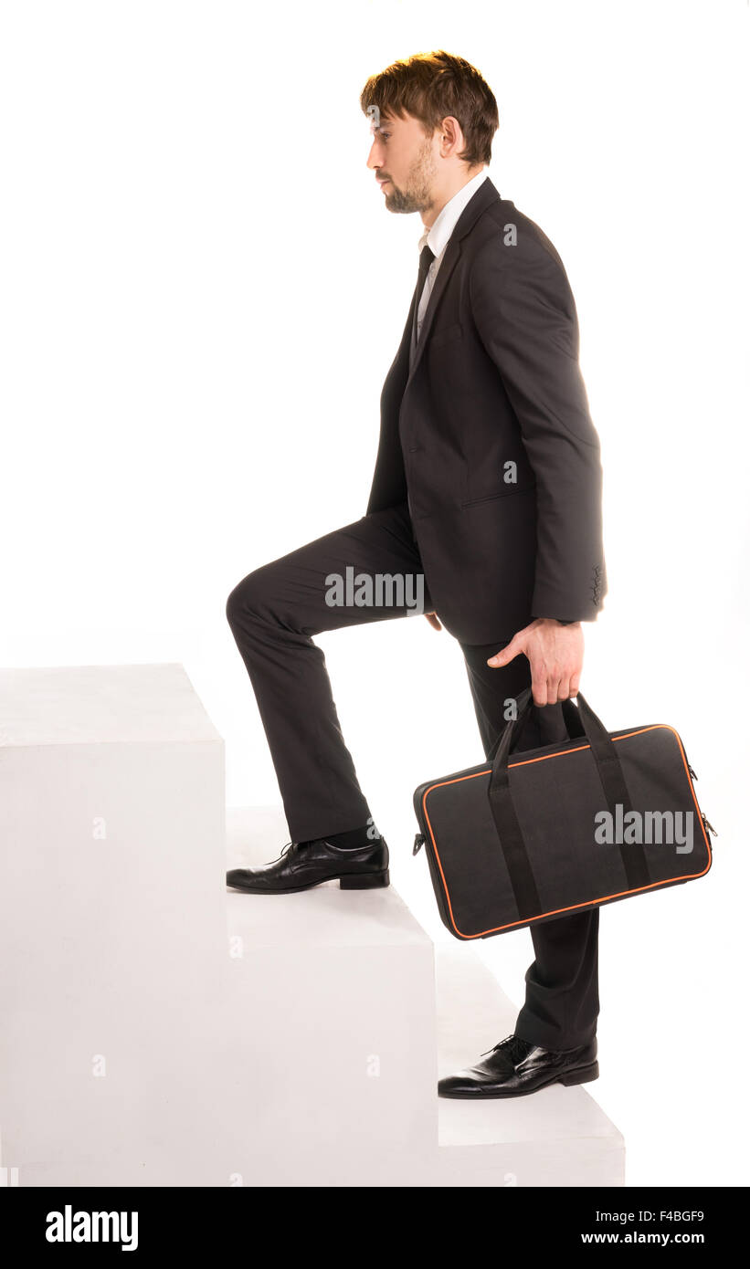 Imprenditore a salire le scale con una valigetta Foto Stock