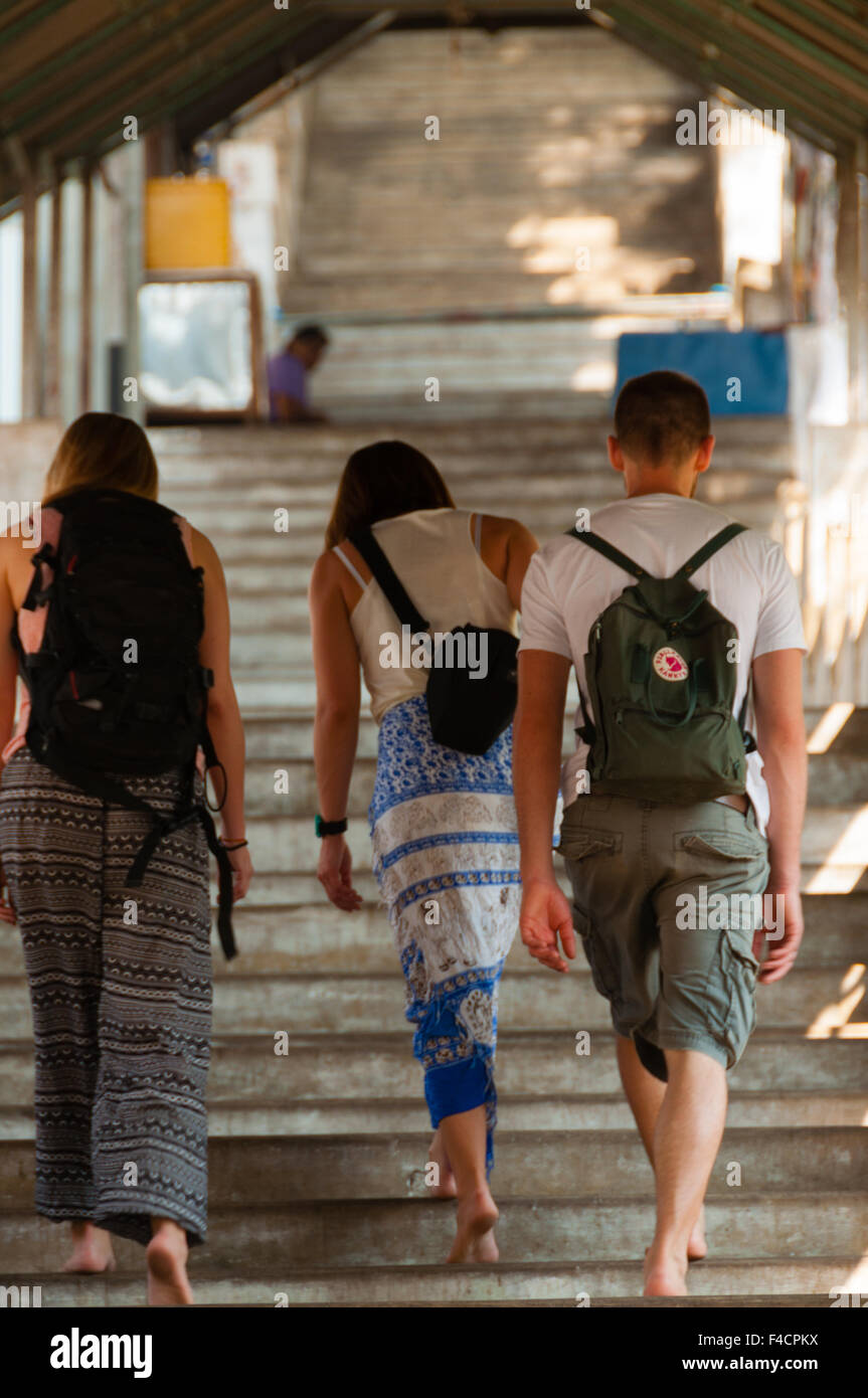 Tre viaggiatori a salire le scale del tempio Foto Stock