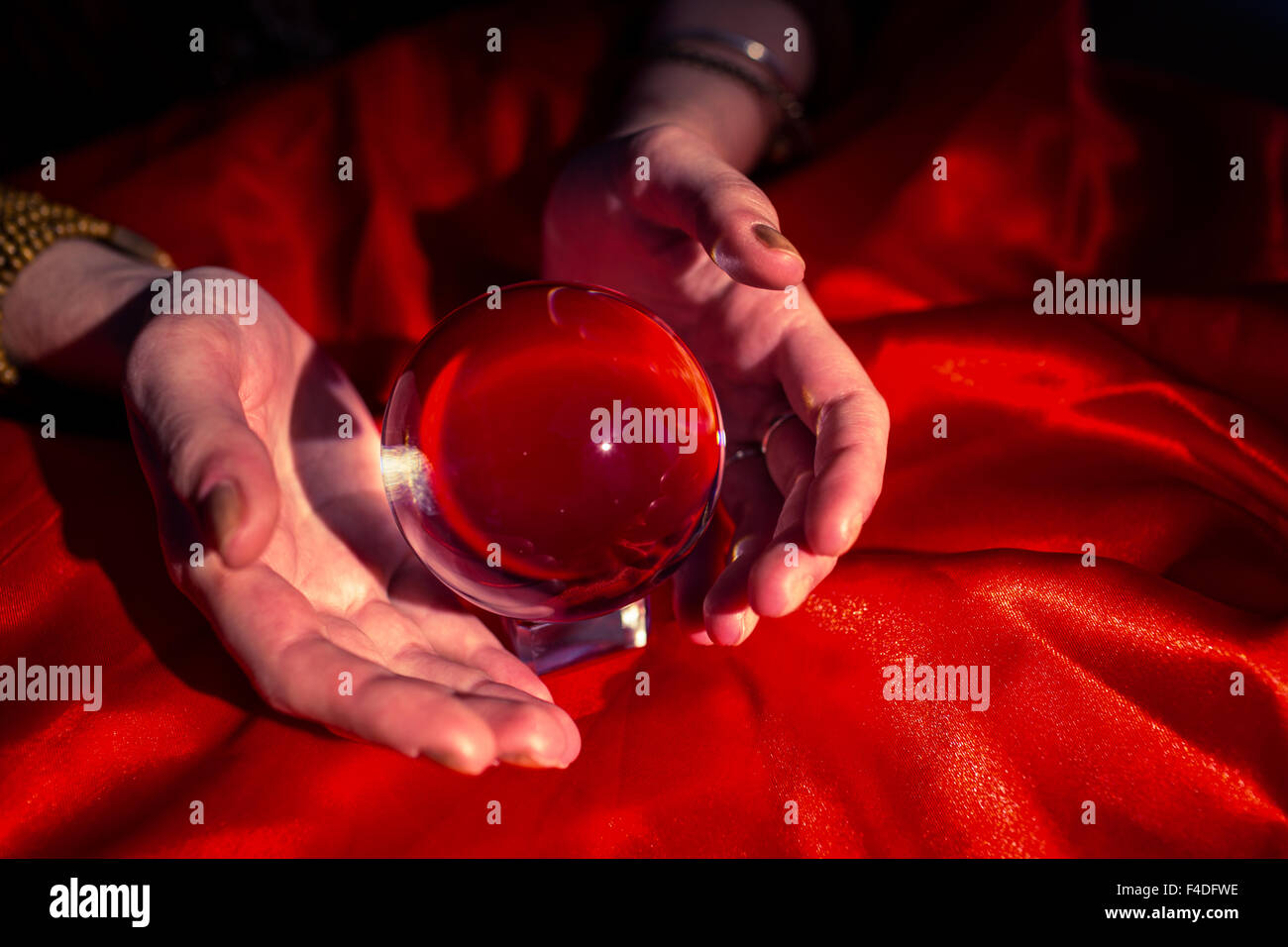 Close-up di mani tagliate di fortune teller con sfera di cristallo Foto Stock