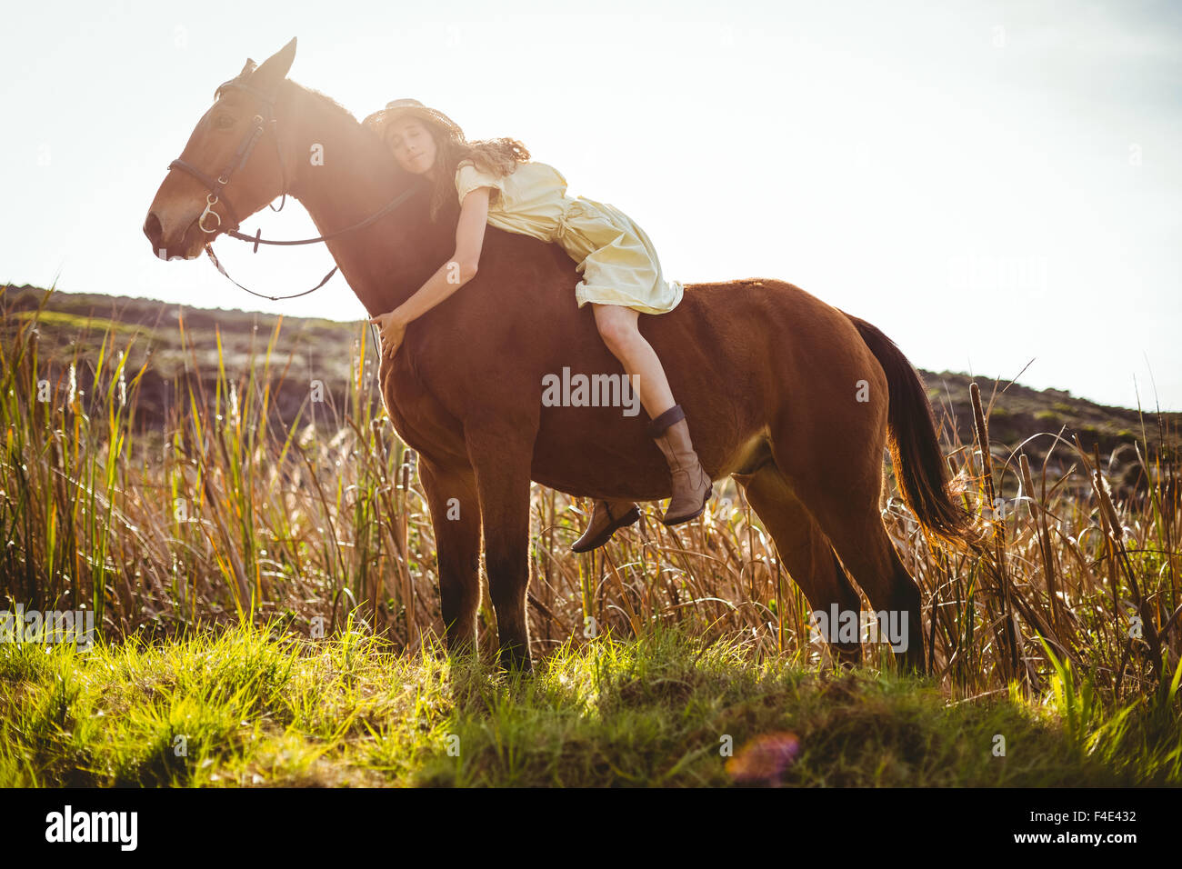 Giovane donna felice in sella il suo cavallo Foto Stock