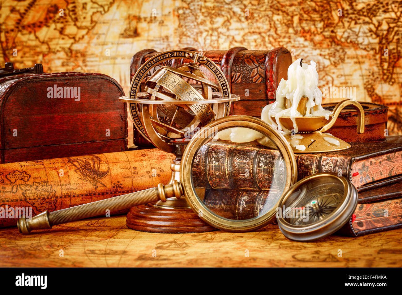Vintage ancora in vita. Vintage lente di ingrandimento bugie, orologio da tasca, vecchio libro e sfera armillare su una antica mappa del mondo nel 1565. Foto Stock