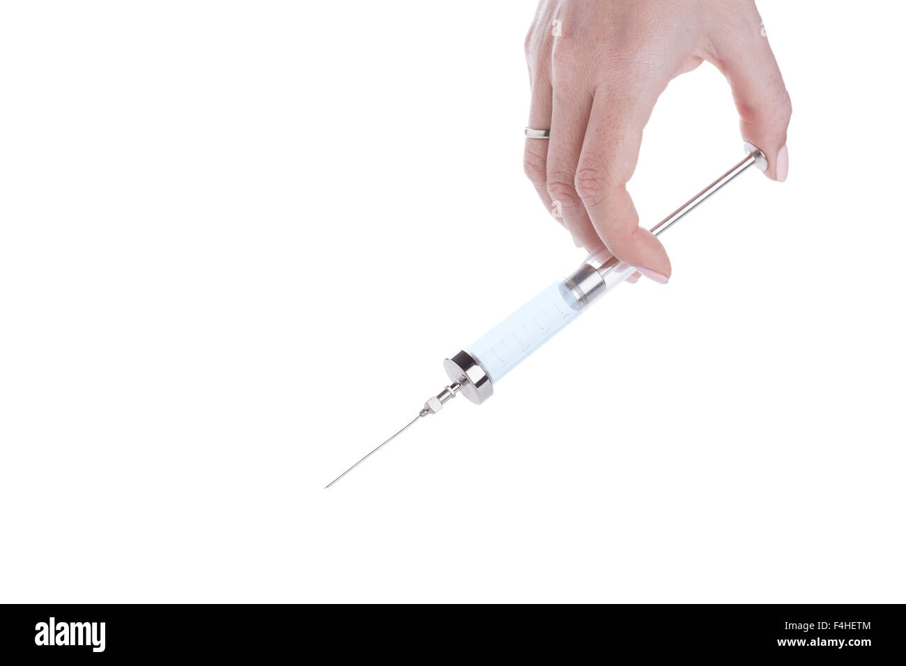 Vetro Antico più utilizzare la siringa in mano femminile, primo piano su sfondo bianco Foto Stock